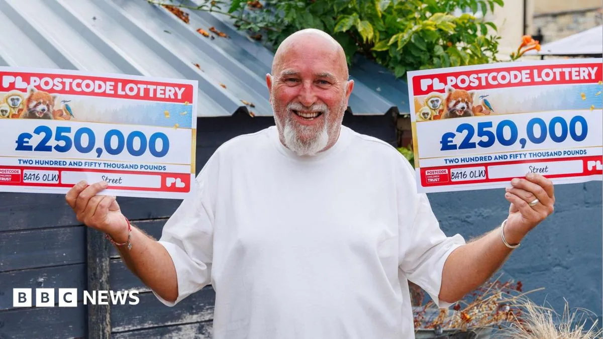 Rick Robinson poses after winning £500,000 on the Postcode Lottery in Street, Somerset